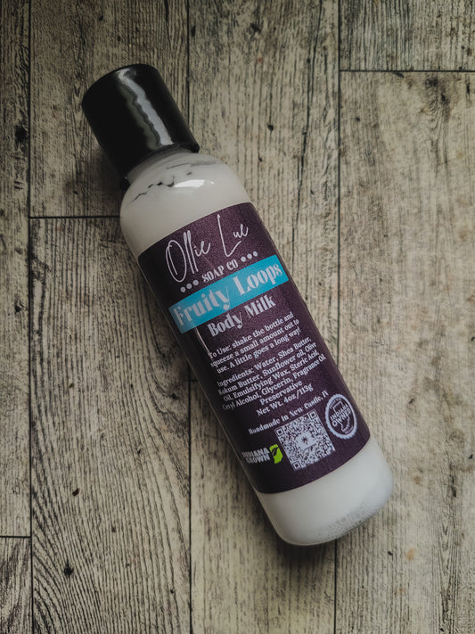 Bottle of Ollie Lue Body Lotion on a wooden surface