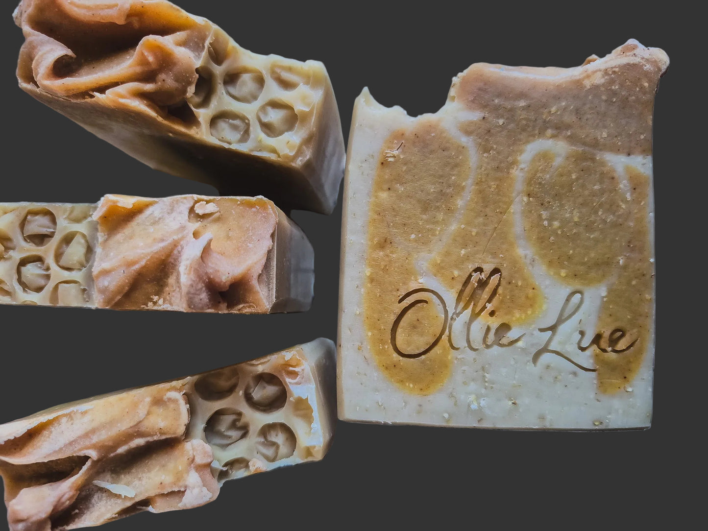 Close-up of honeycomb-textured soap with 'Ollie Lue' branding on a dark background