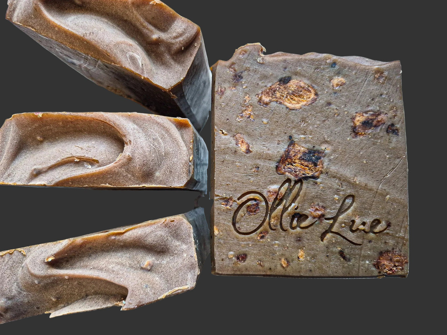 Close-up of a bar of soap with 'Ollie Lue' branding on a dark background
