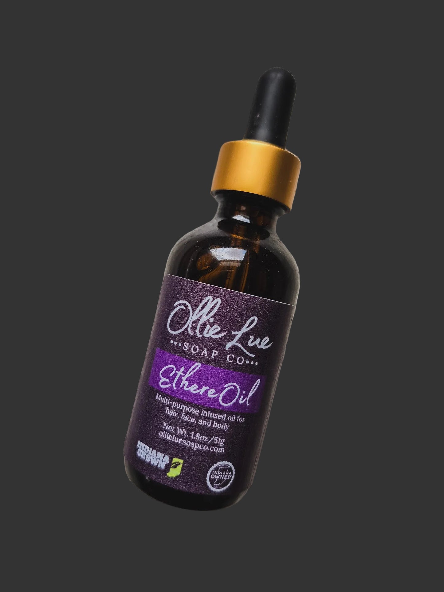 Bottle of Ollie Live Soap Co. Ethere Oil on a wooden surface