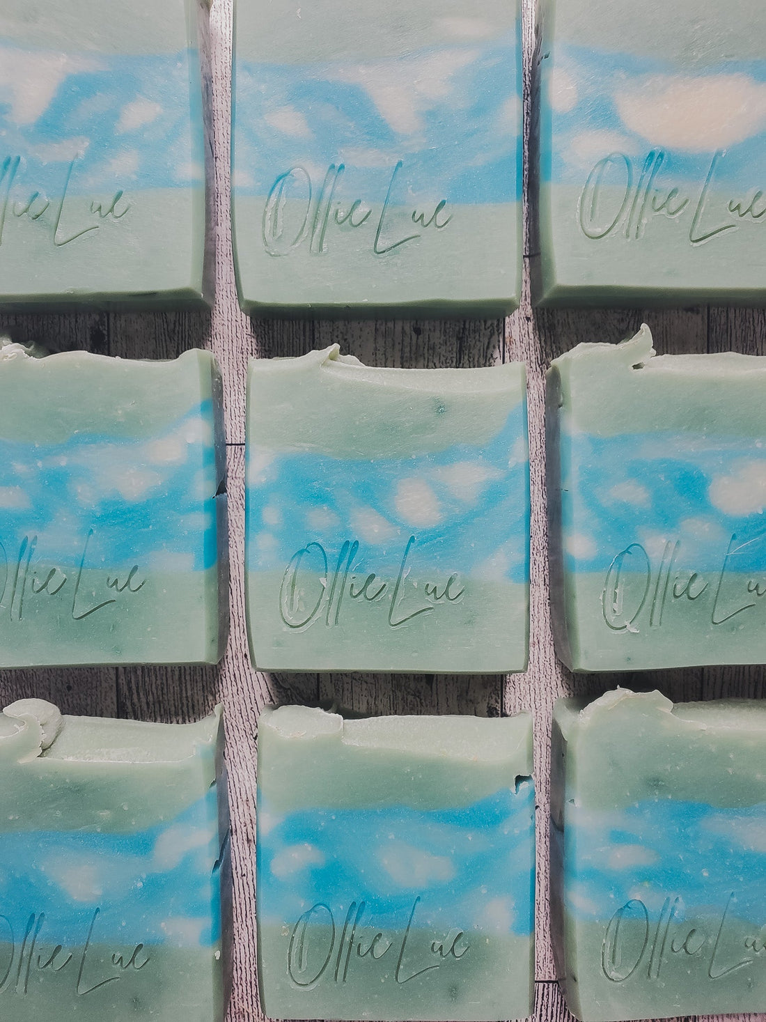 green soap with blue and white swirl middle on a wooden surface