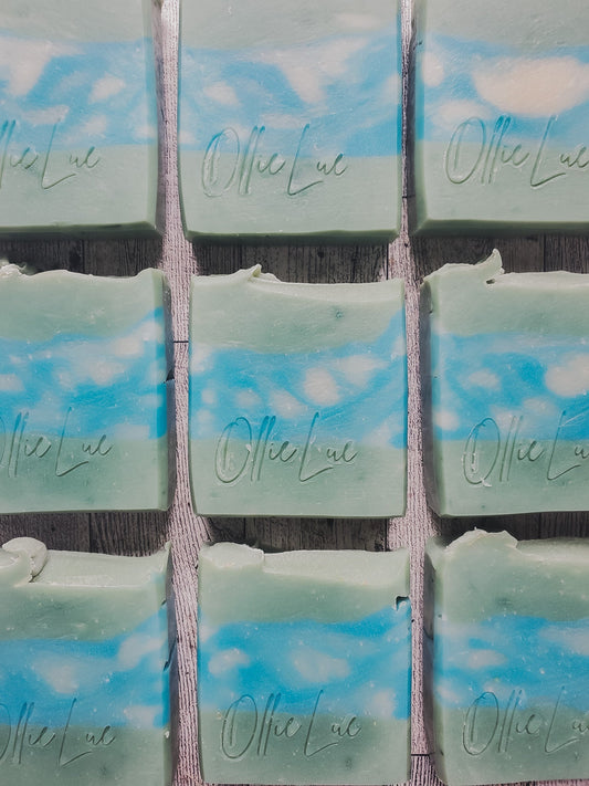 green soap with blue and white swirl middle on a wooden surface