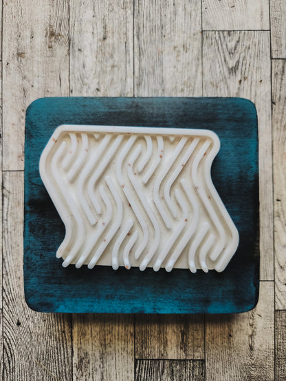 White soap dish on a blue wooden stand 