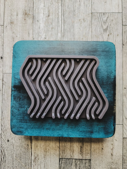 gray soap dish on a blue wooden stand