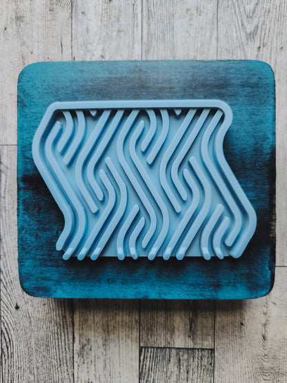 blue soap dish on a blue wooden stand