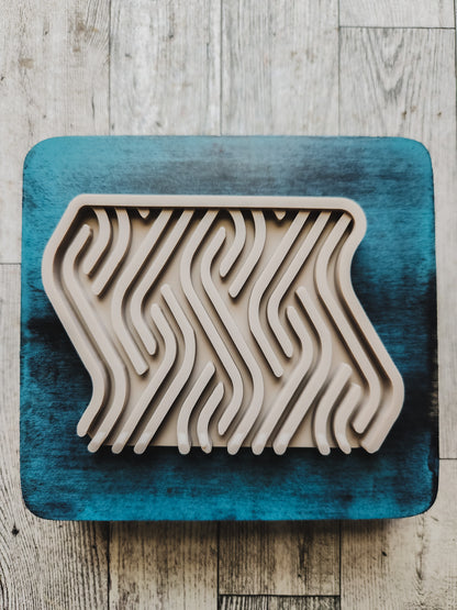 taupe soap dish on a blue wooden stand