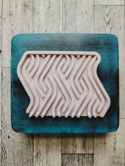 pink soap dish on a blue wooden stand