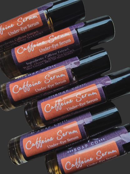 Roll-on bottles of caffeine serum under-eye serum with colorful labels on a dark background