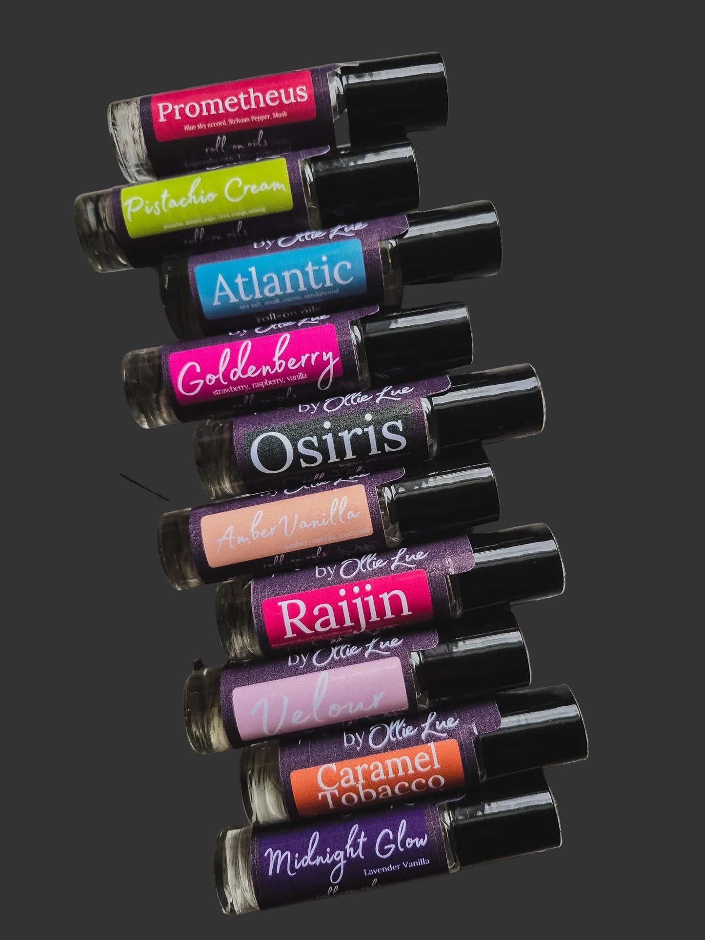 Collection of scented oil tubes with colorful labels on a dark background