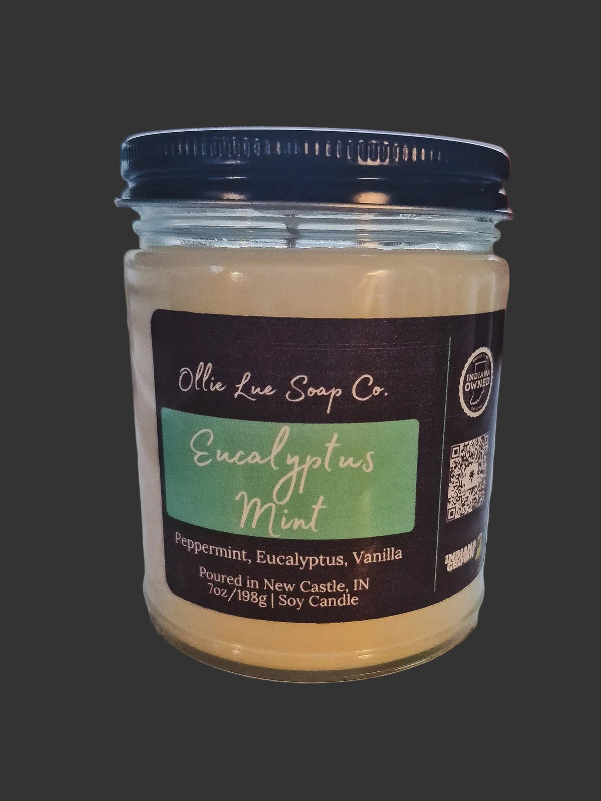 Jar of Eucalyptus Mint Candle Ollie Lue Soap Co. candle with label on a dark background