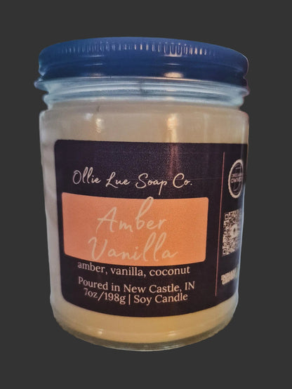 Jar of Amber Vanilla candle with Ollie Lue Soap Co. label on a dark background
