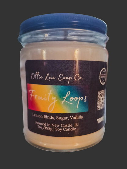 Jar of Fruity loops candle with 'Ollie Lue Soap Co.' label on a dark background