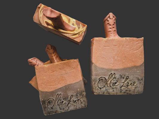 a layered brown to dark brown soaps with a cowboy boot on top and stamped Ollie Lue on each bar
