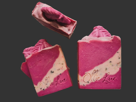 pink soap on a wooden surface with a pink horse in it. stamped ollie lue.