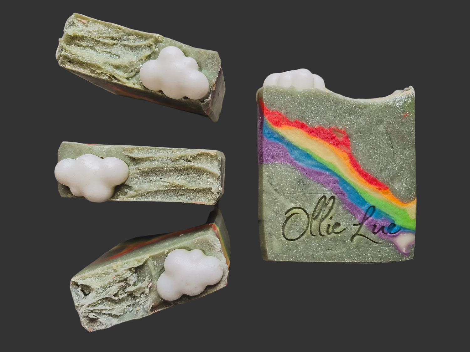 sparkle blue/green soap with a rainbow in the middle, topped with a cloud soap and stamped ollie lue on each bar
