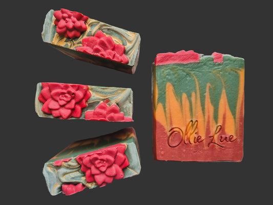 a green, orange and red layered soap topped with a desert rose all stamped ollie lue