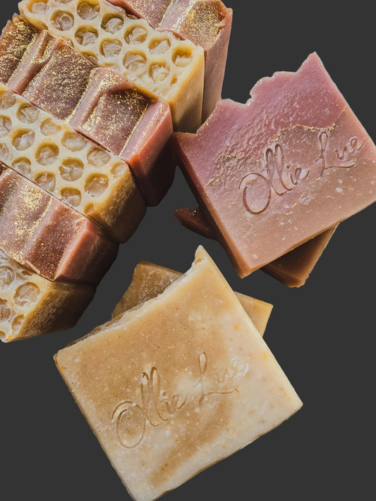 handmade soaps on a wooden surface stamped 'ollie lue'