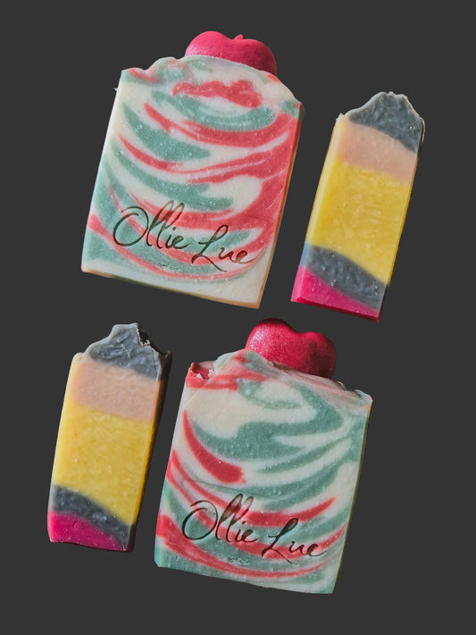 Colorful swirled soap bars with 'Ollie lue' branding on a textured surface