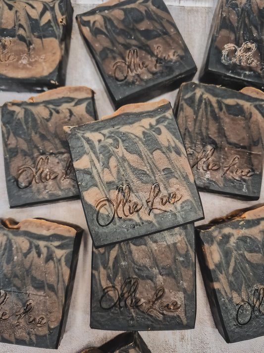 black and brown soap stamped Ollie Lue on a gray background