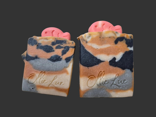 calico colored soap on dark background with a soap fish on top stamped Ollie Lue